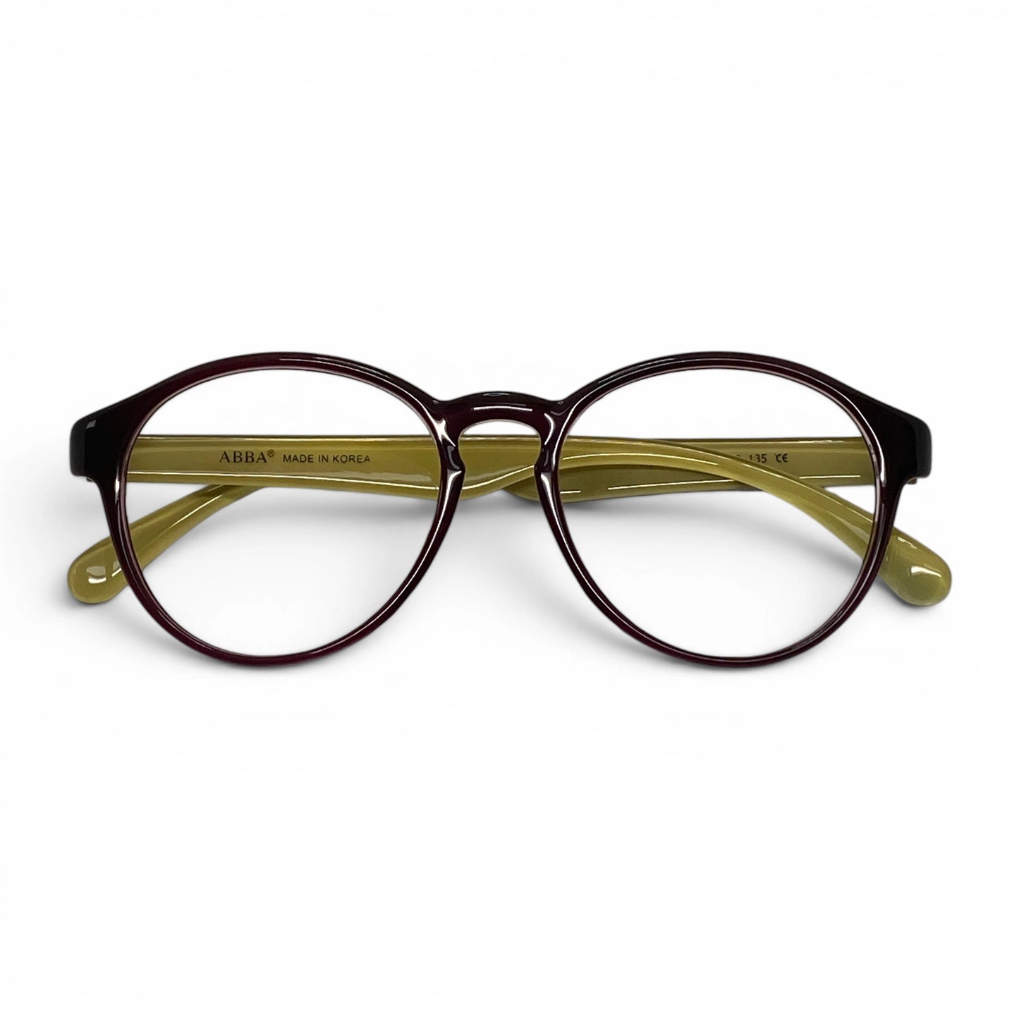 Brown glossy round eyeglasses with yellow arms on a white background