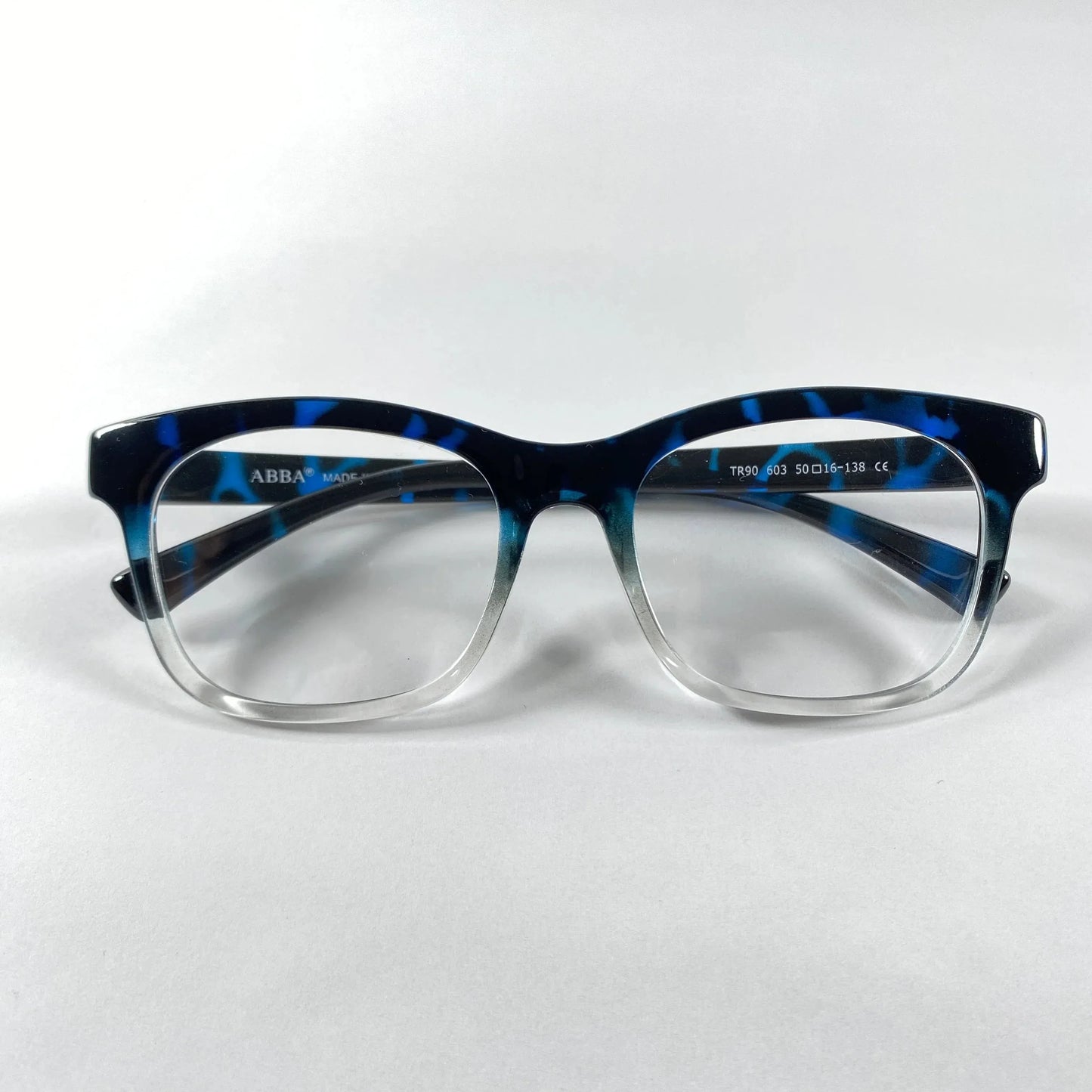Blue marble pattern eyeglasses with transparent bottom frame on white background