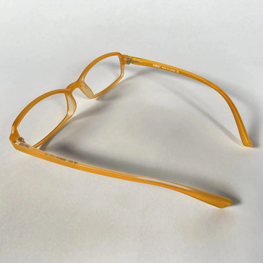Orange kids eyeglass frames side view on white background