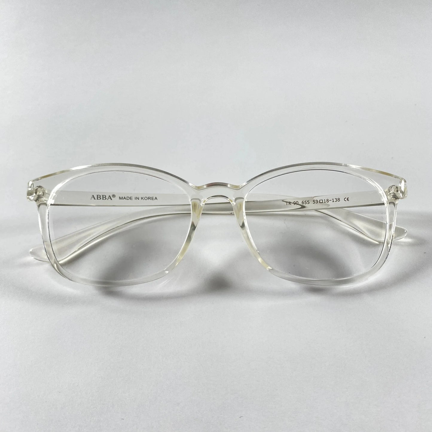 Clear Vion eyeglasses with transparent frame on white background, sporty style detail