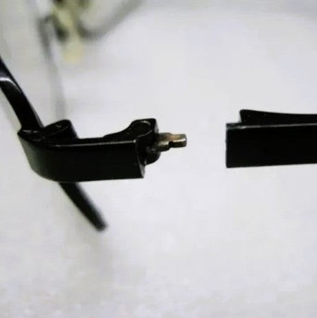 Cracked eyeglasses, a snapped hinge showing common frame damage