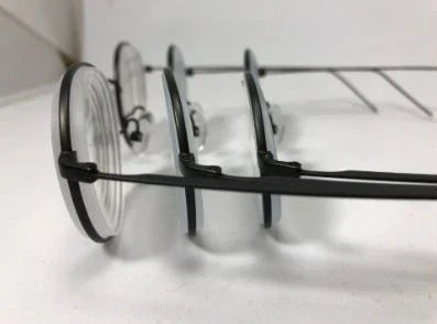 Side-by-side lens thickness comparison showing how 1.74 high-index lenses are significantly thinner than standard lenses for high prescriptions