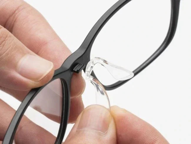 VionGlasses attachable nosepads being installed on eyeglass frame for personalized comfort and custom fit