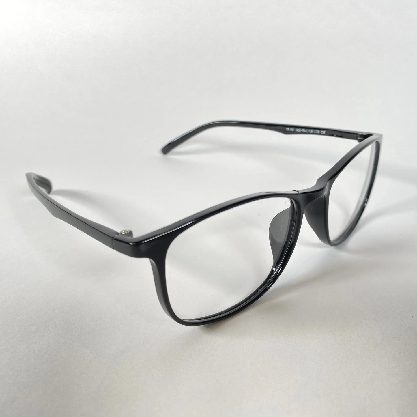 Black square eyeglasses with clear lenses on a white background, modern glasses style
