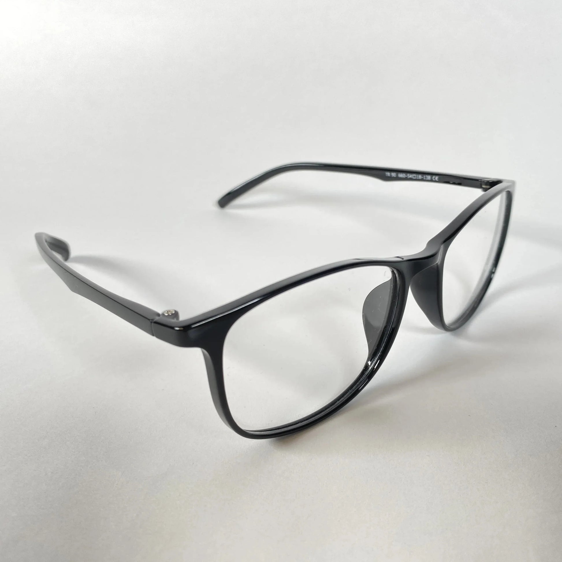 Black square eyeglasses with clear lenses on a white background, modern glasses style