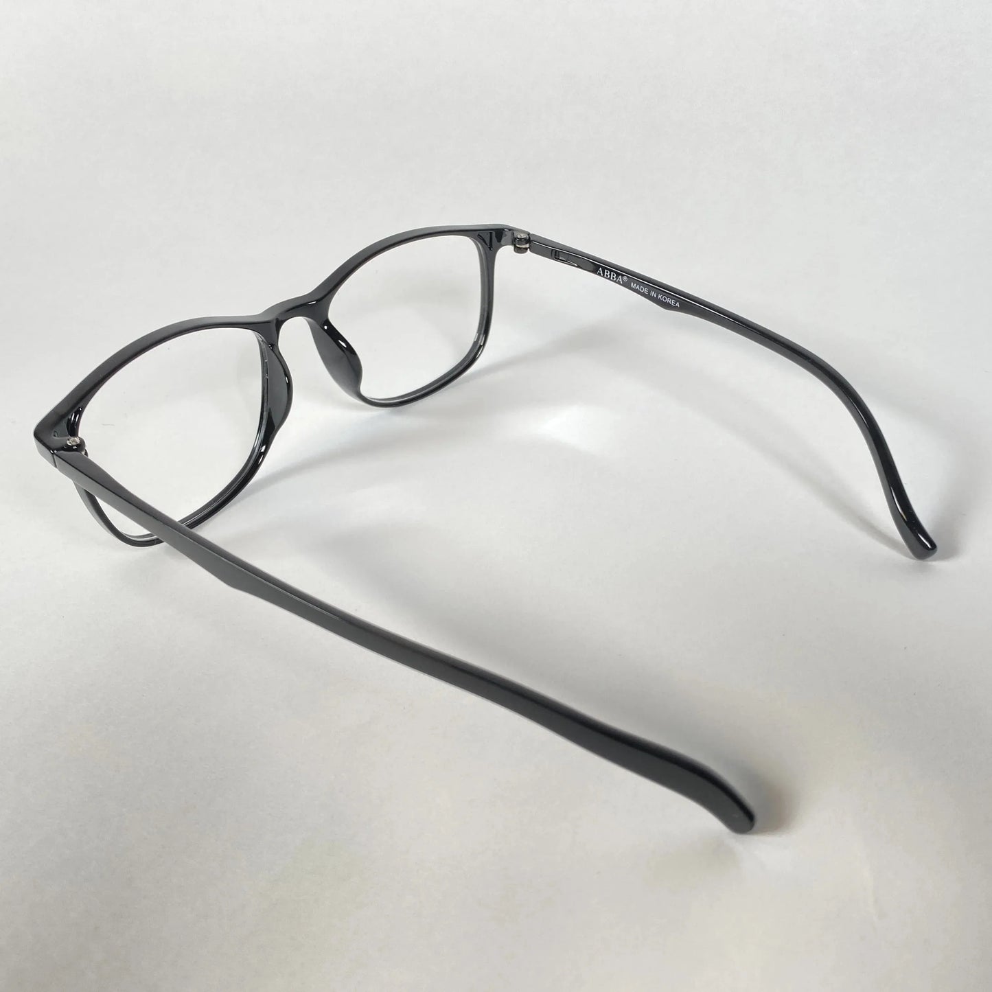 Black full-rim eyeglasses with clear lenses on a white background