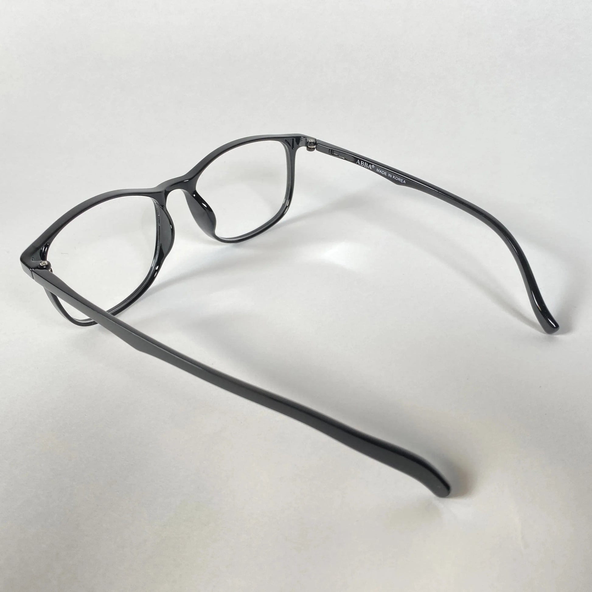 Black full-rim eyeglasses with clear lenses on a white background