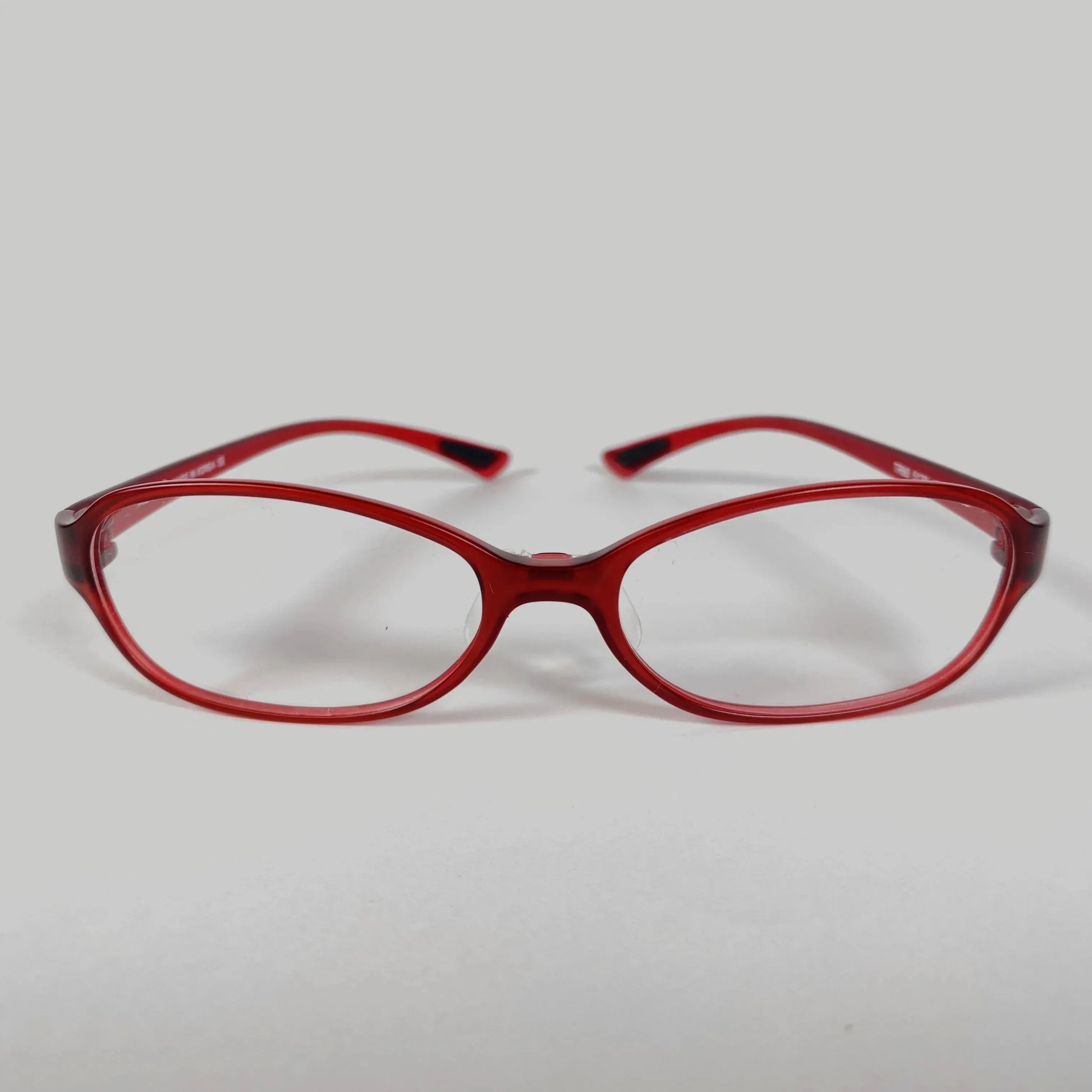 Red sporty eyeglasses with clear lenses on plain white background