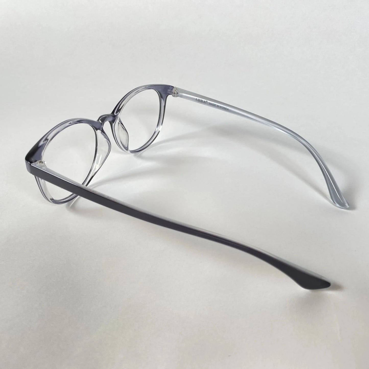 Navy transparent eyeglasses with round frames on white background
