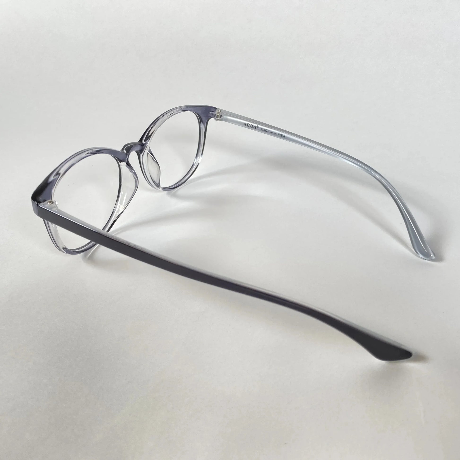 Navy transparent eyeglasses with round frames on white background