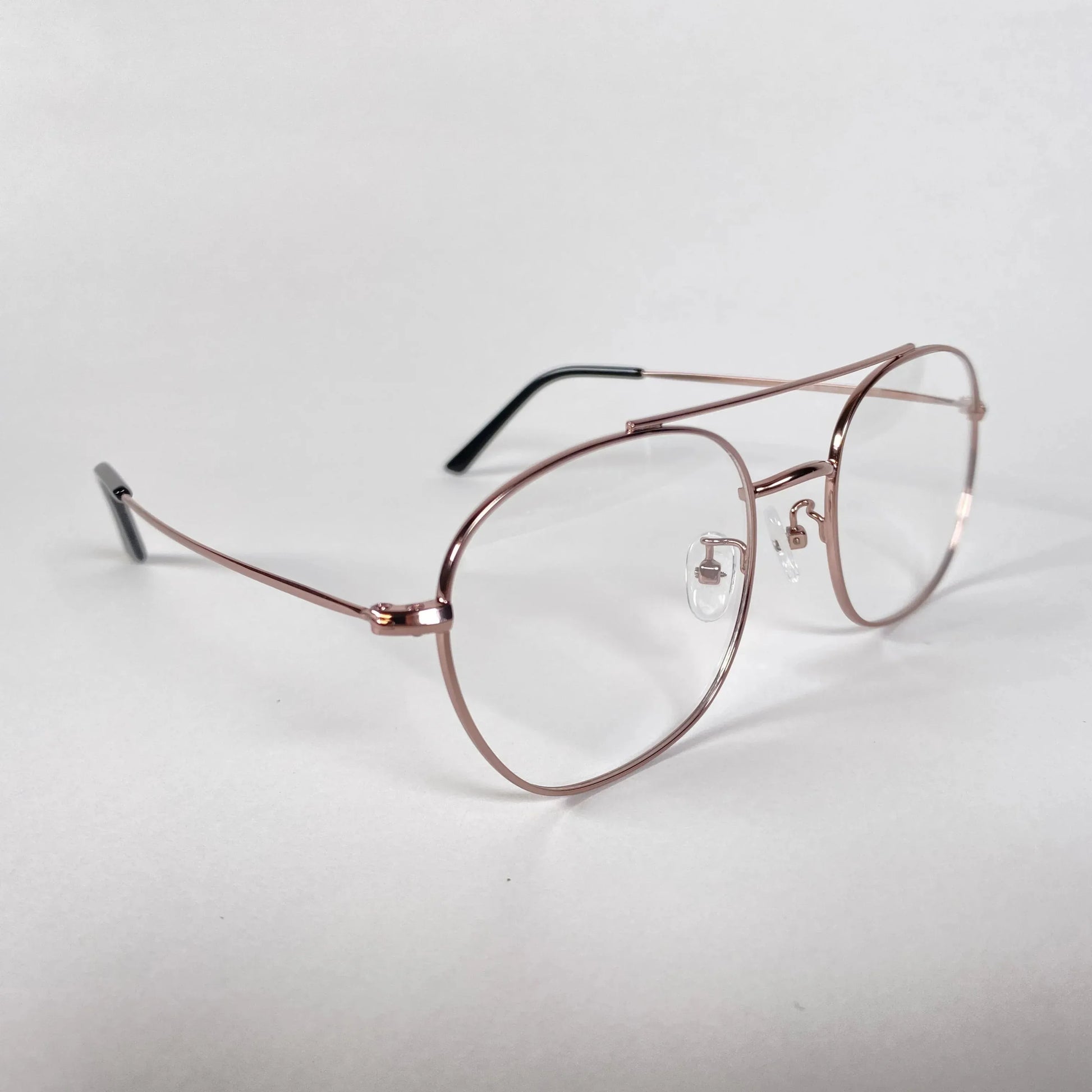 Rose gold aviator eyeglasses with clear lenses on white background