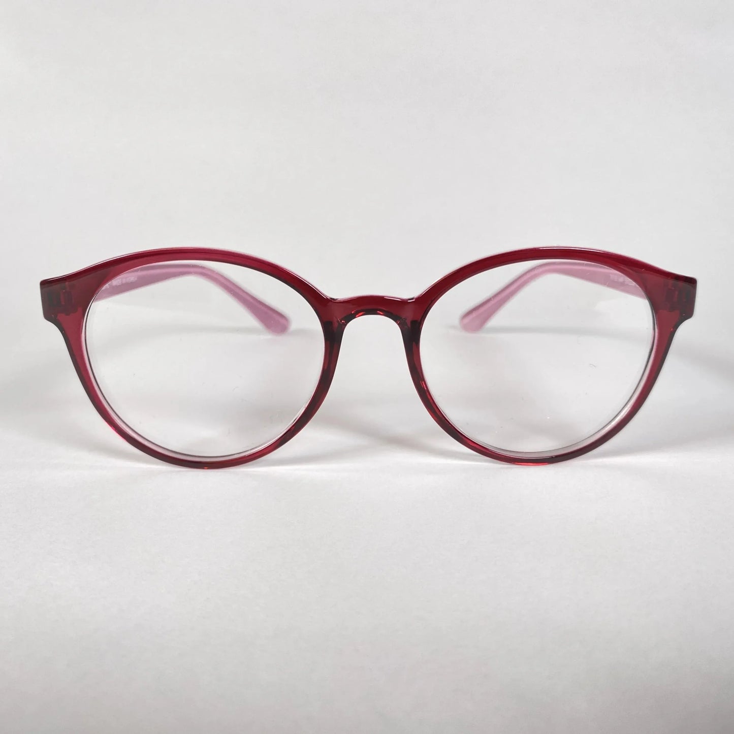 Round burgundy eyeglasses with clear lenses on a white background