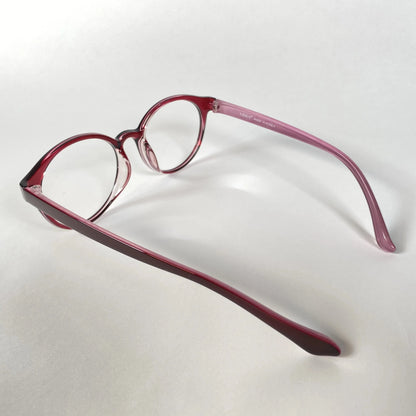 Round burgundy eyeglasses with clear lenses on a white background