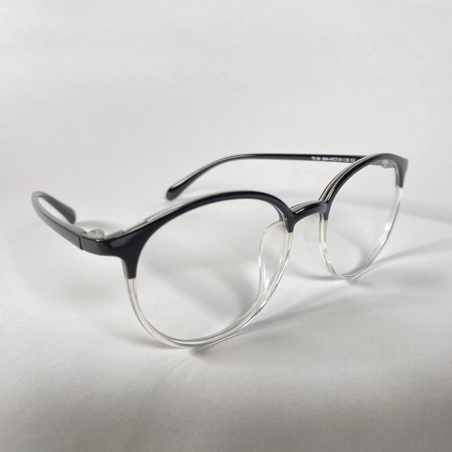 Round black and clear acetate eyeglasses on white background