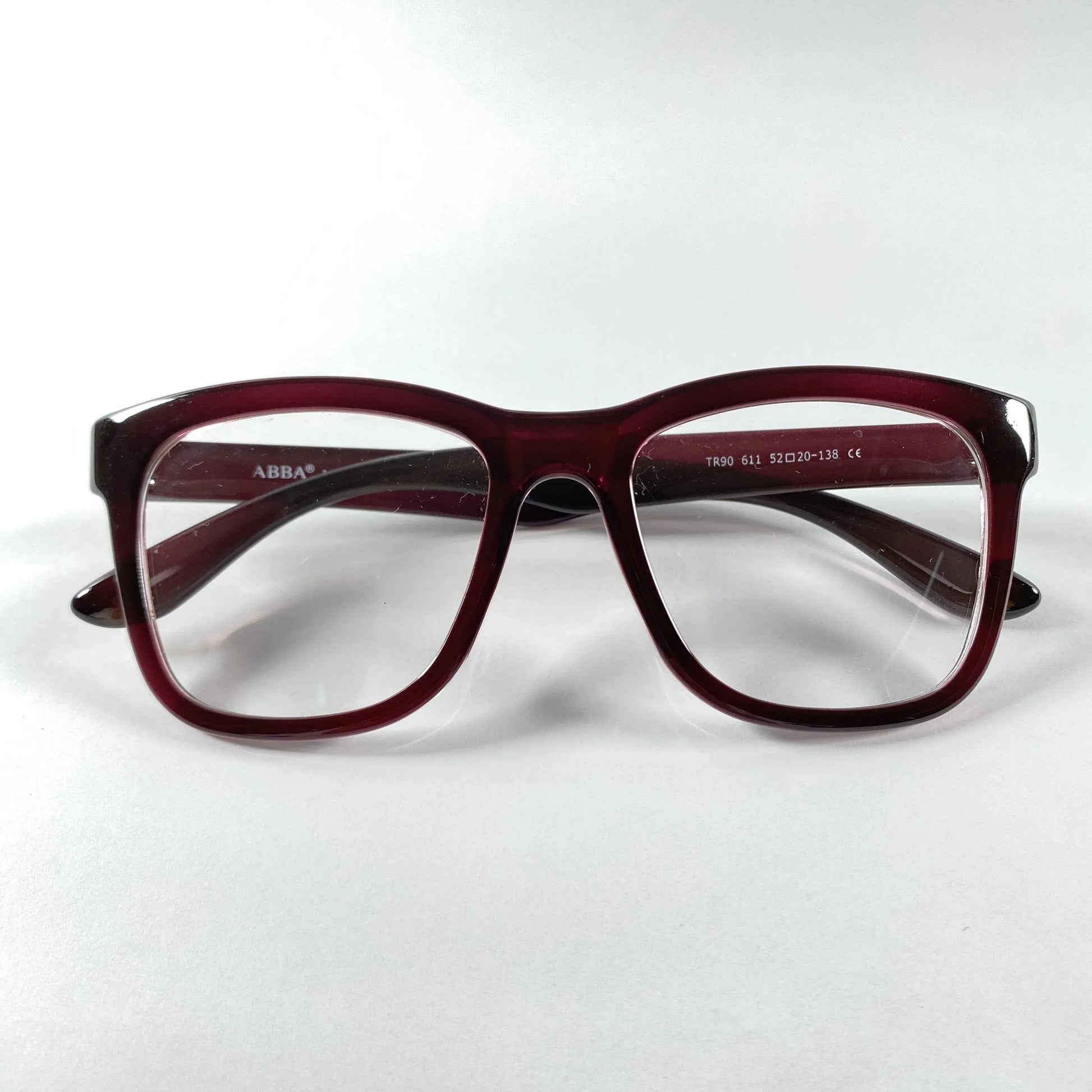 Maroon horn rimmed eyeglasses front view on white background