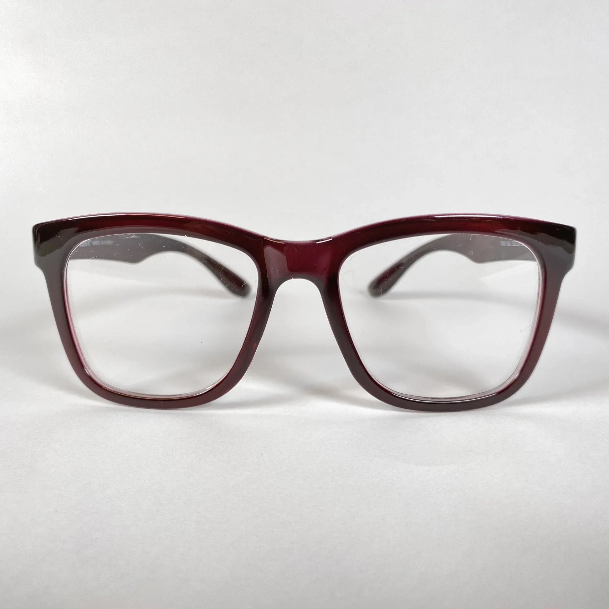 Front view of burgundy horn-rimmed eyeglasses with square lenses on white background
