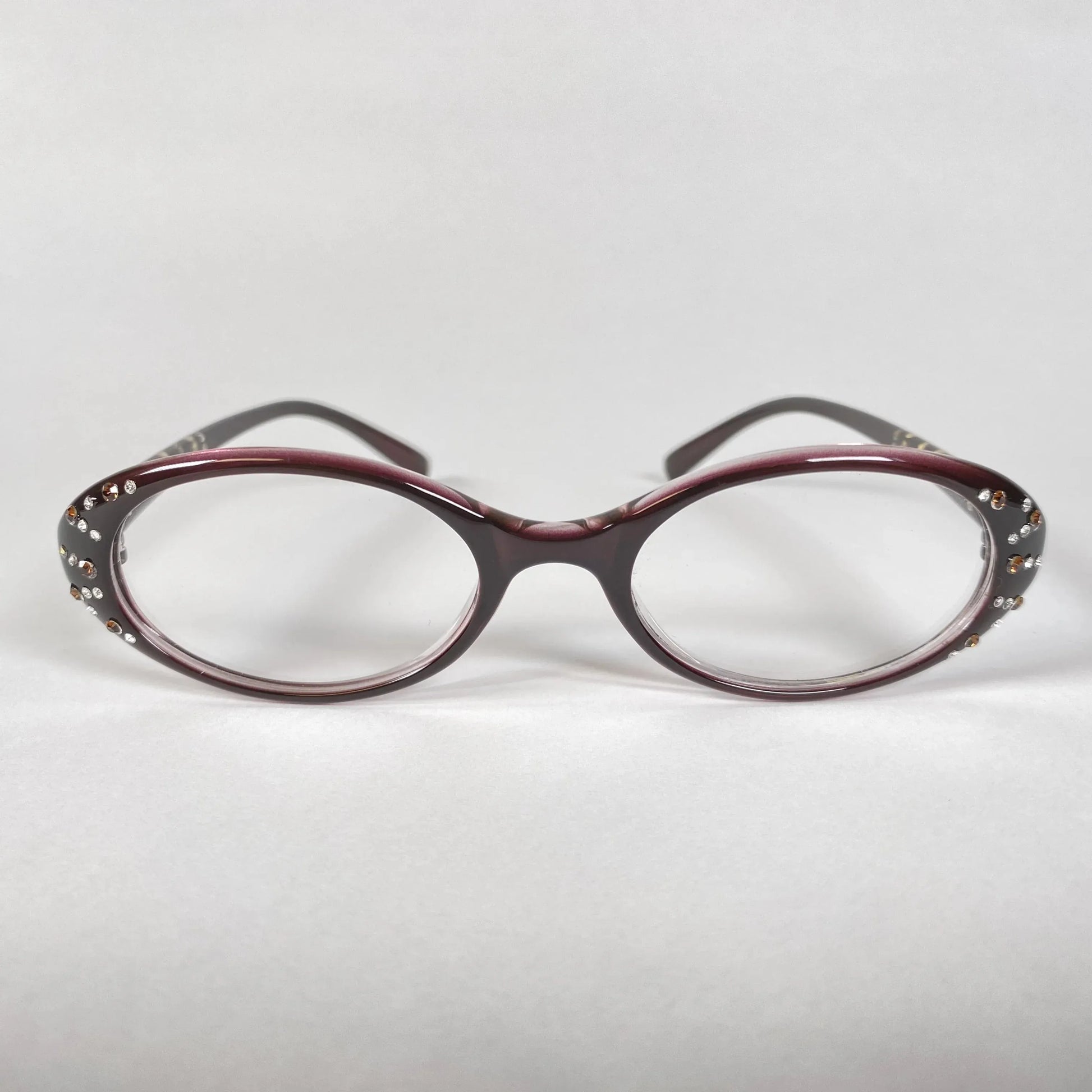 Oval burgundy eyeglasses with crystal accents on frame, stylish eyewear on white background