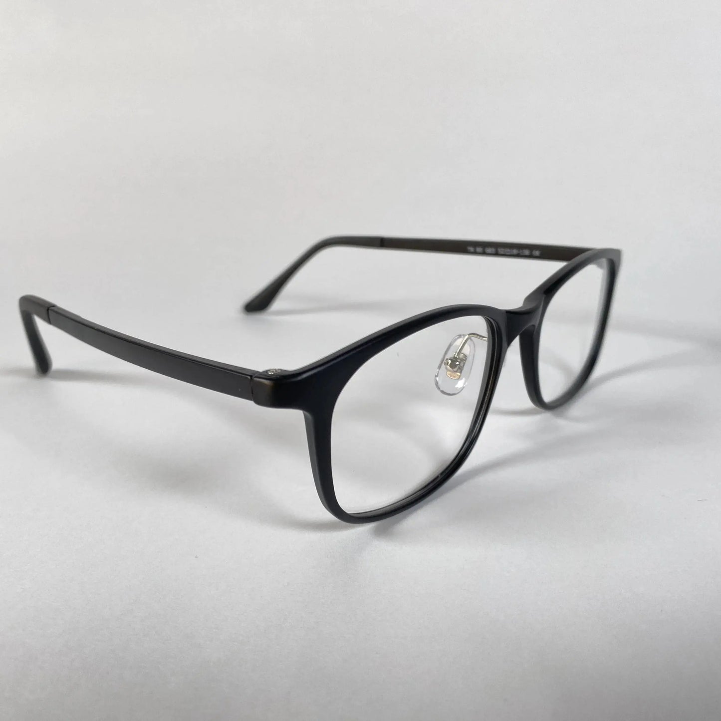 Black square eyeglasses with clear lenses and nose pads on a white background