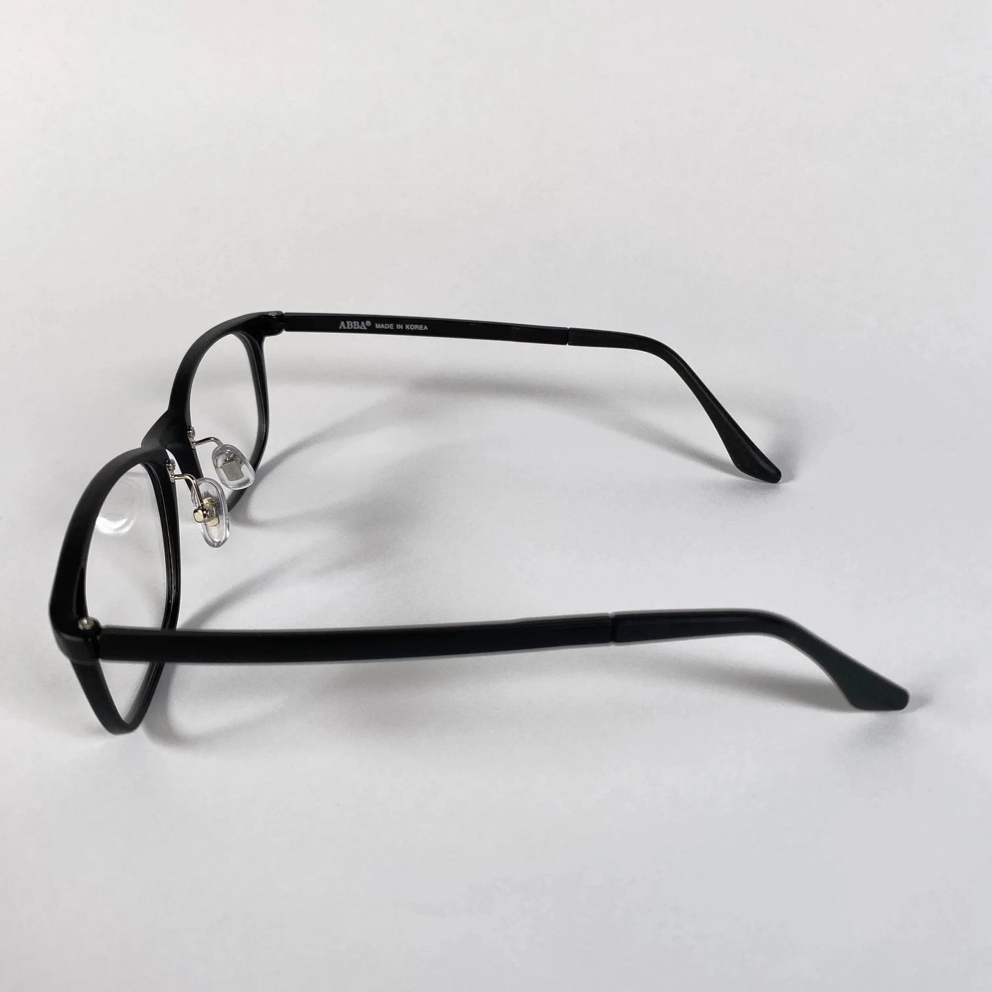 Black square eyeglasses frame side view on white background