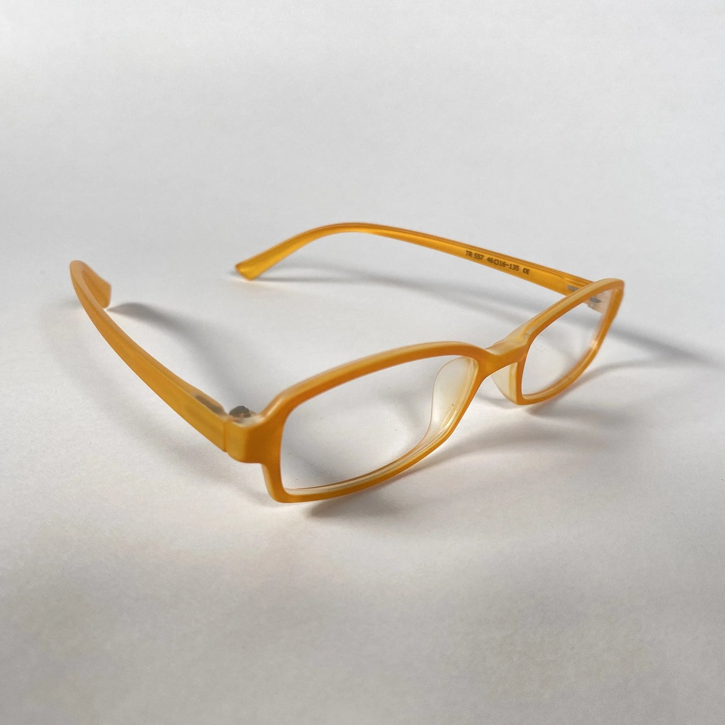 Orange kids eyeglasses with rectangular frames on white background