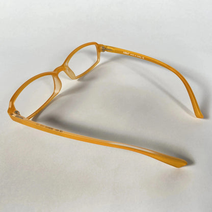 Orange kids eyeglass frames side view on white background