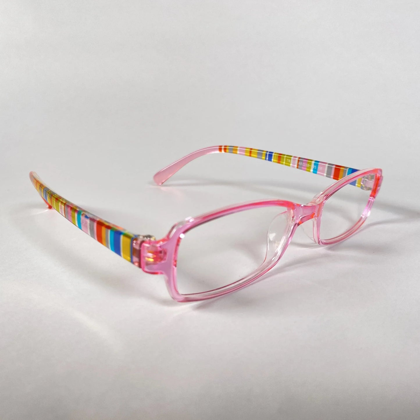 Pink kids glasses with clear lenses and colorful striped arms on white background