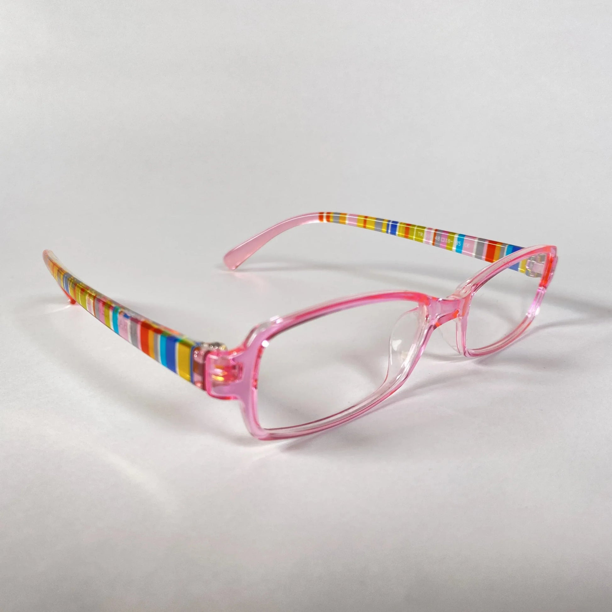 Pink kids glasses with clear lenses and colorful striped arms on white background