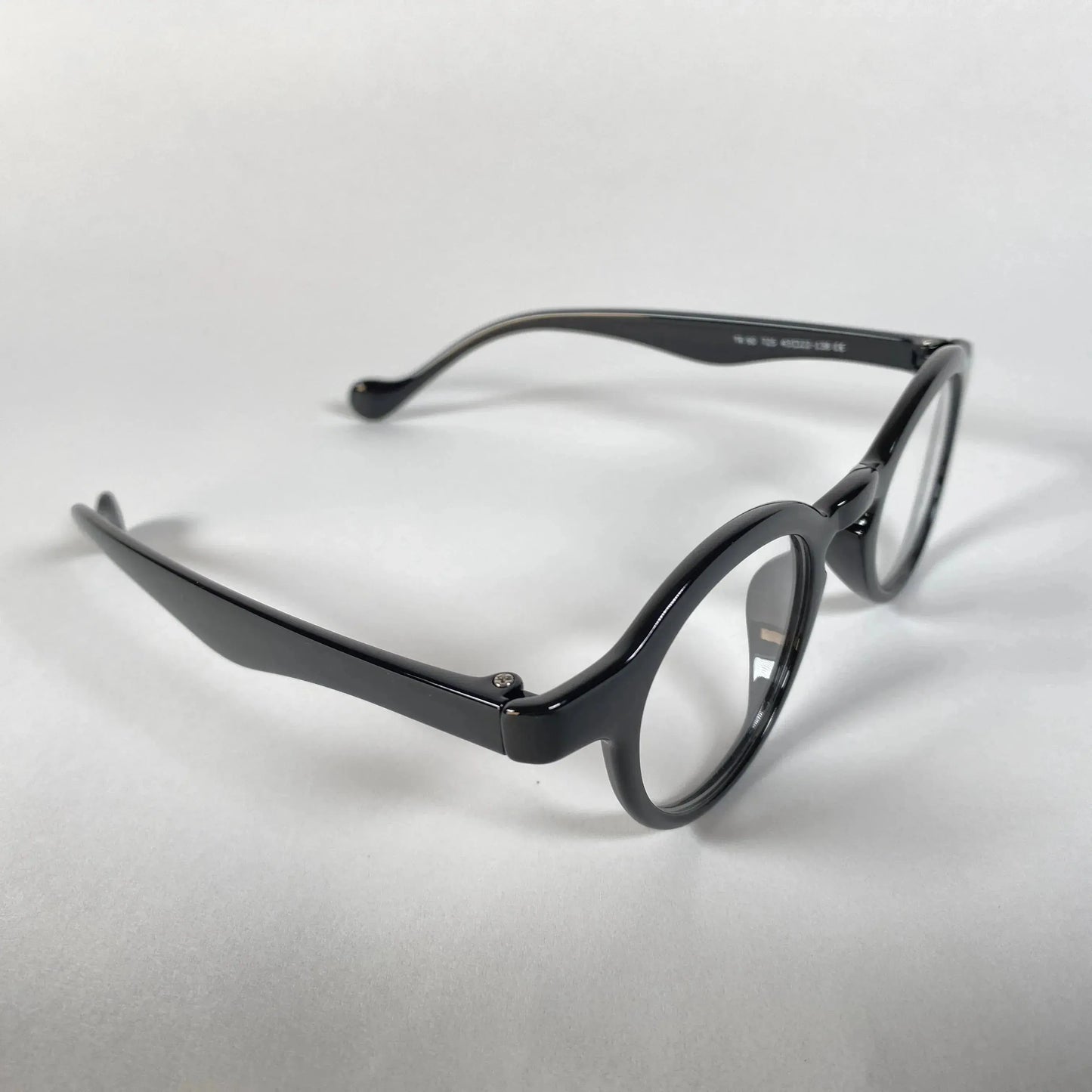 Round black metal eyeglasses with clear lenses on a white background