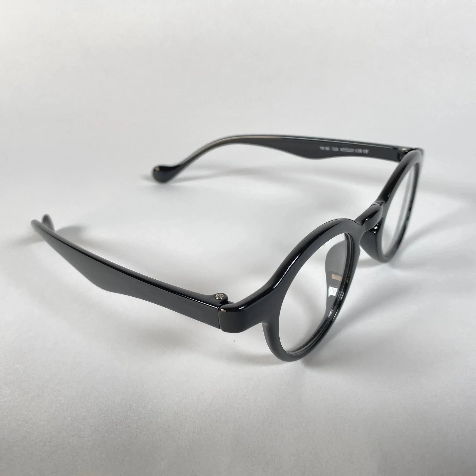 Round black metal eyeglasses with clear lenses on a white background