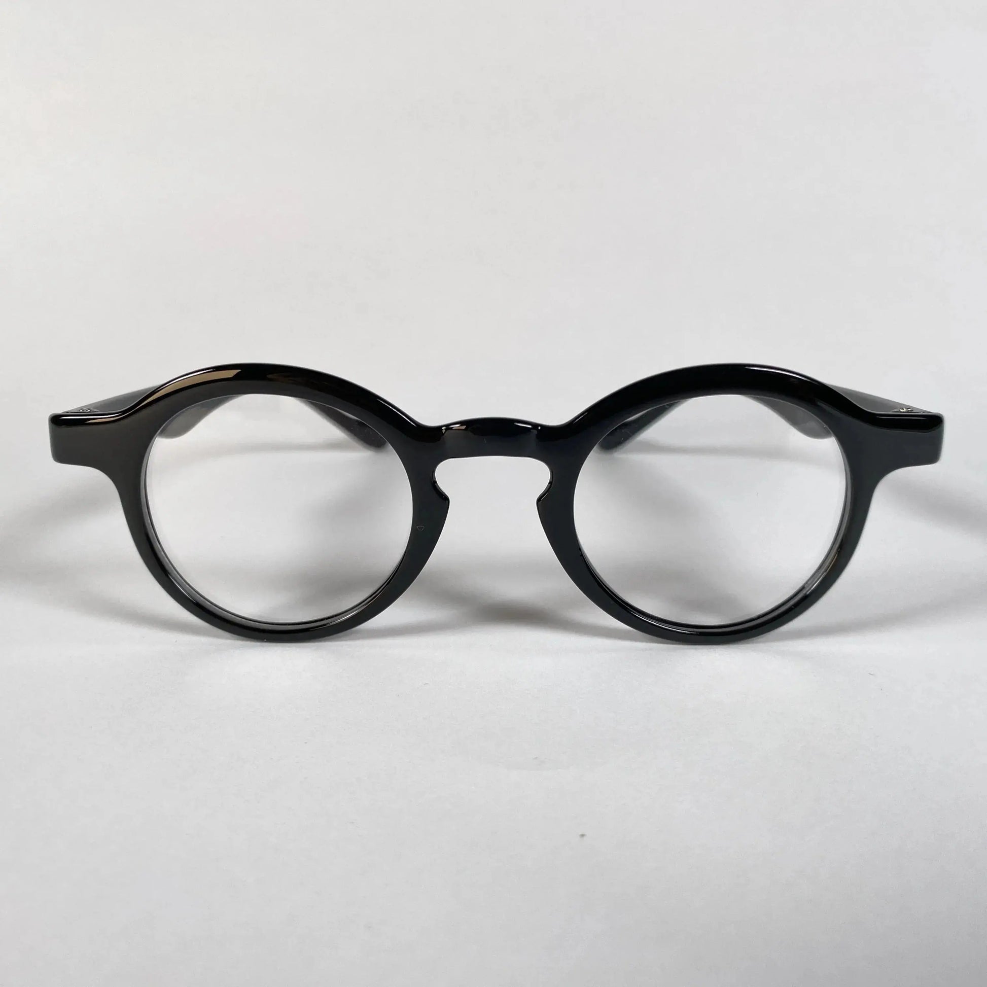 Black round metal eyeglasses with thick frame on white background