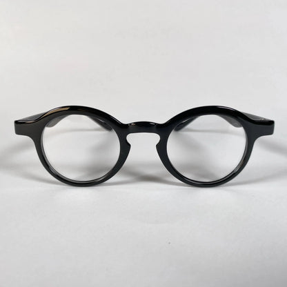 Black round metal eyeglasses with thick frame on white background