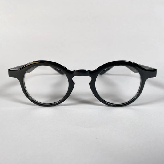 Black round metal eyeglasses with thick frame on white background