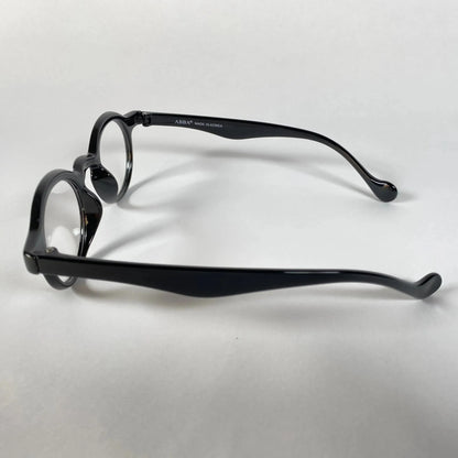 Black round metal eyeglasses with curved arms on white background
