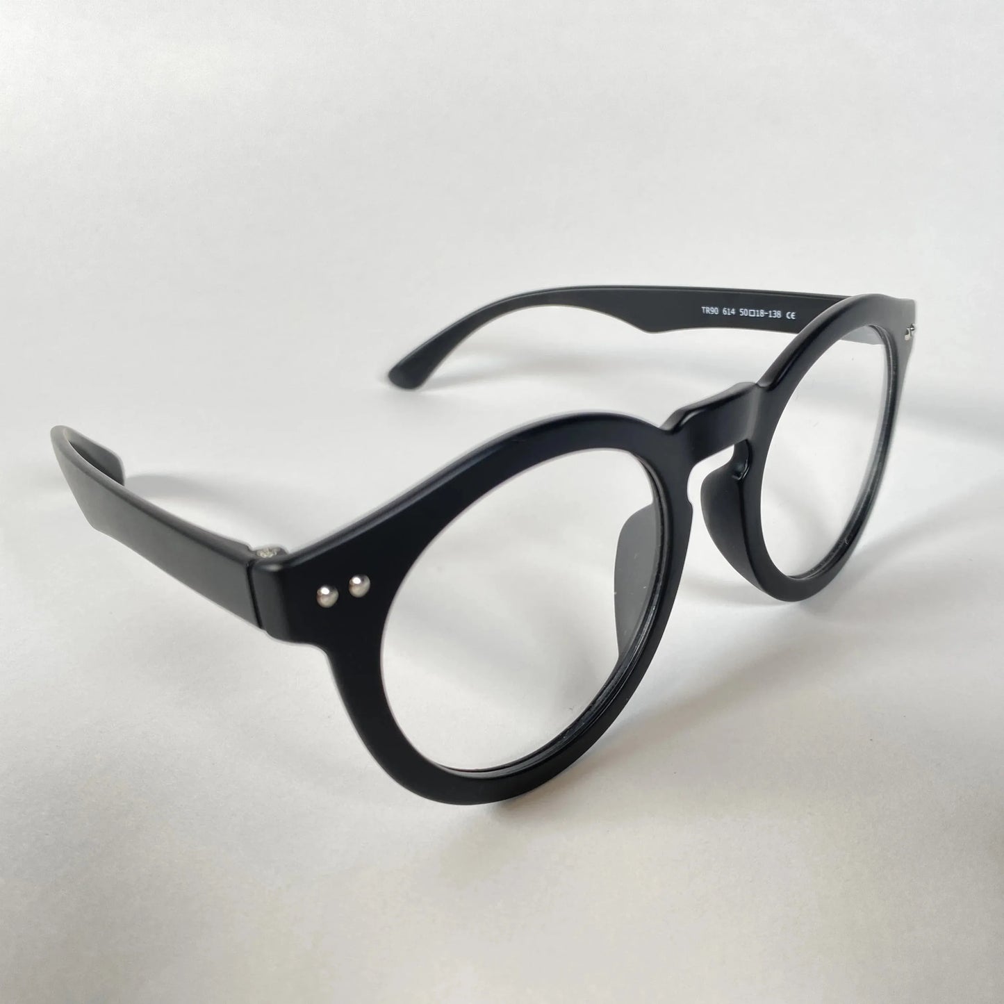 Black round eyeglasses with thick frames on a white background