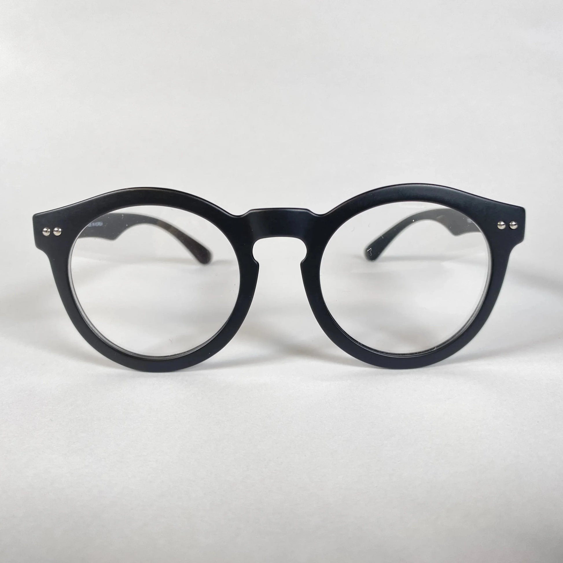 Black round eyeglasses with thick frame on white background, modern eyewear style