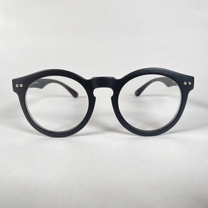 Black round eyeglasses with thick frame on white background, modern eyewear style