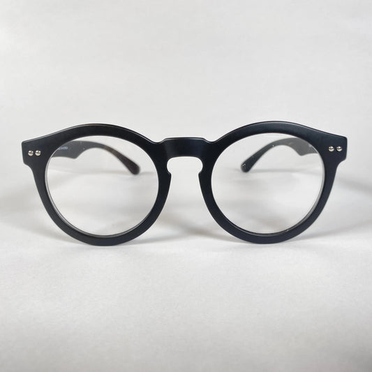 Black round eyeglasses with thick frame on white background, modern eyewear style