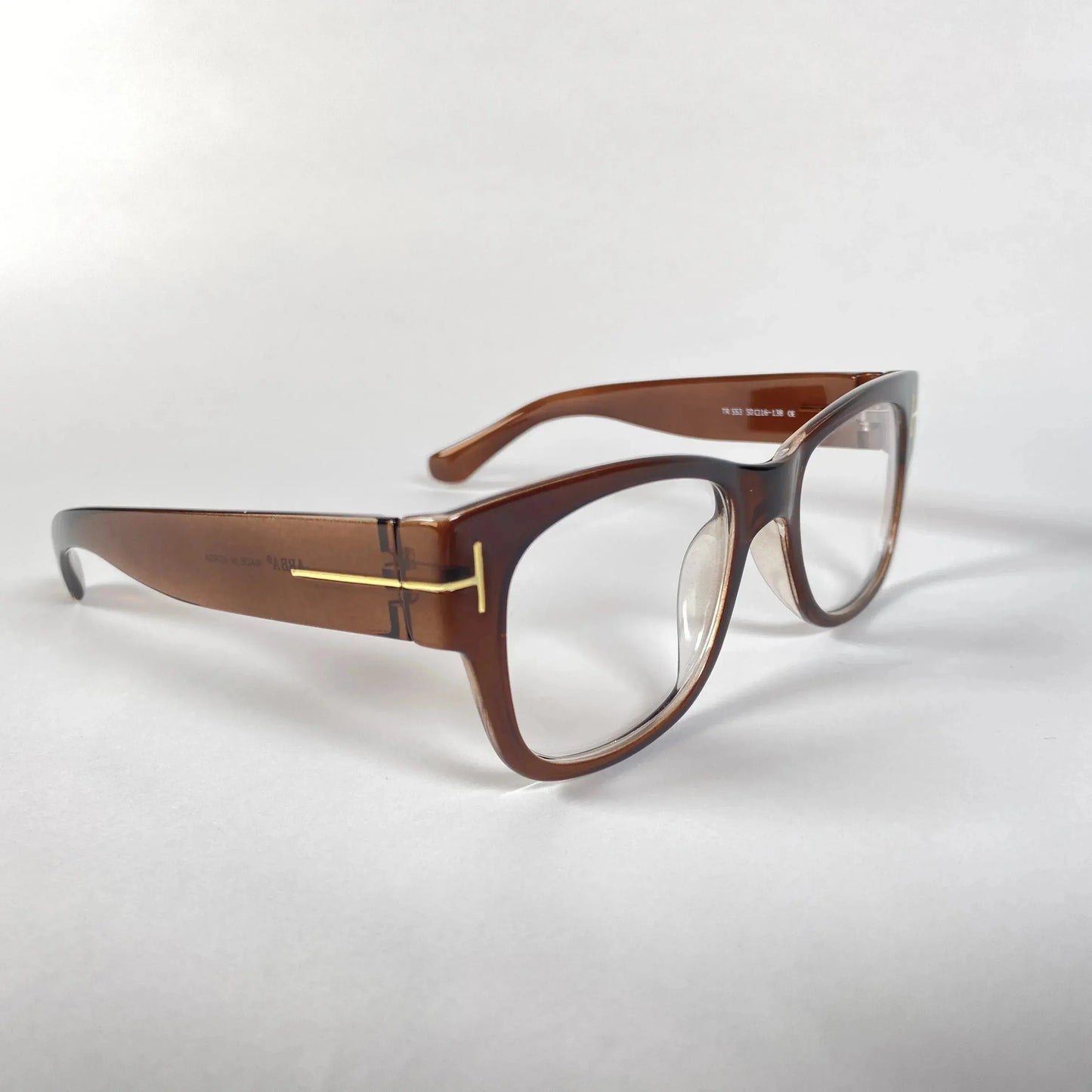 Brown acetate eyeglasses with gold T-shaped temple detail on a white background