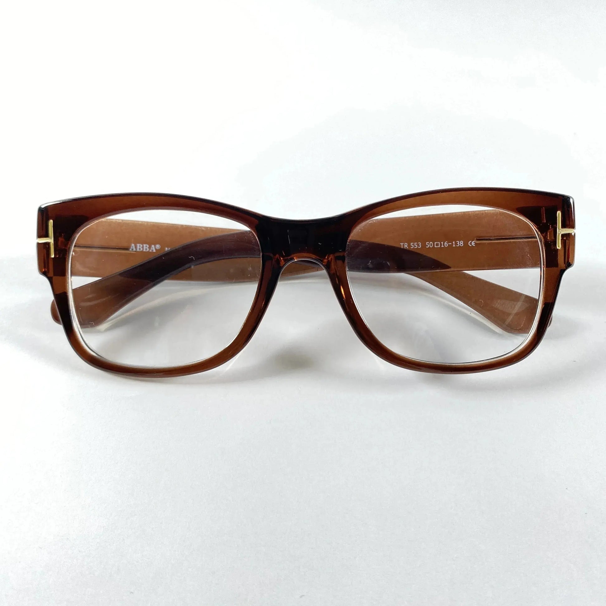 Brown gold detail rectangular eyeglass frame with clear lenses on white background
