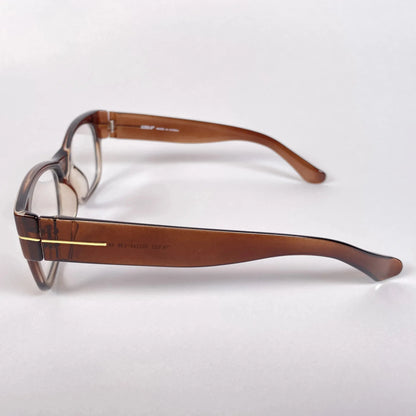 Side view of brown gold acetate eyeglass frames on white background