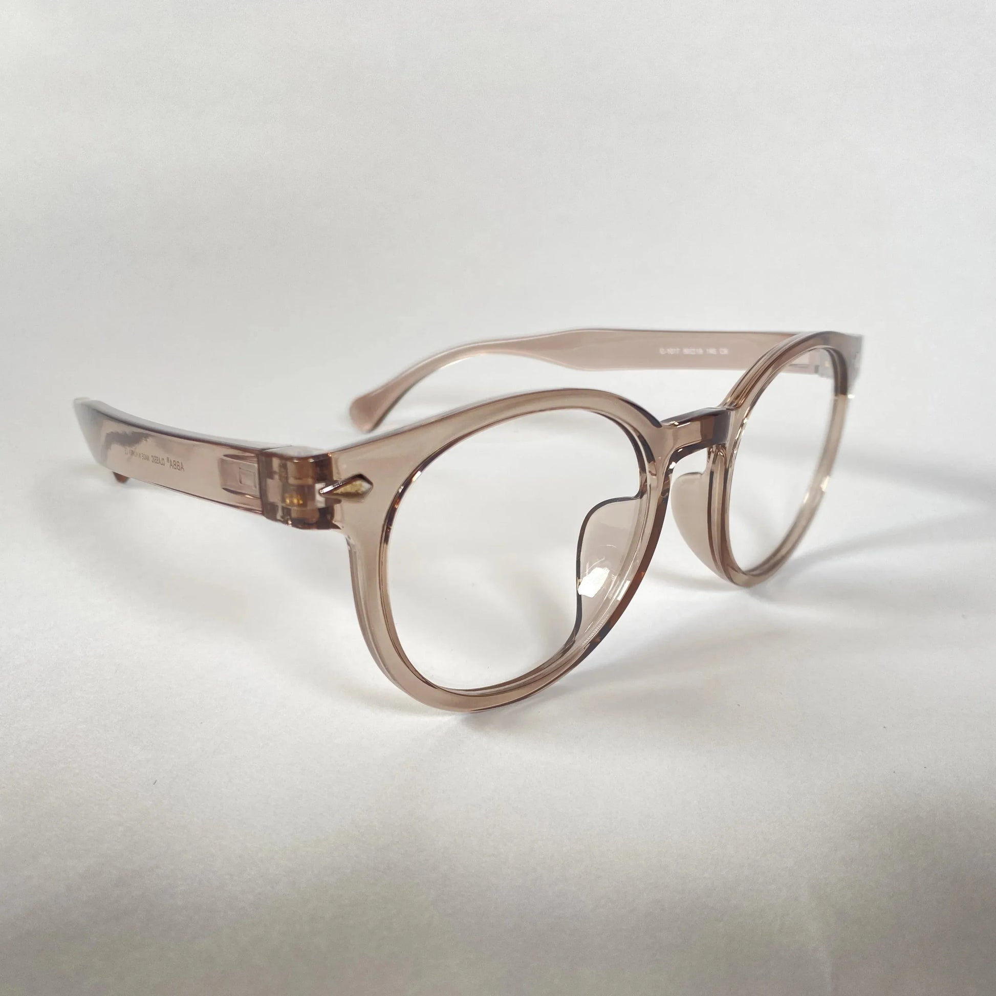 Grey transparent round eyeglasses with thick frames on a plain white background.