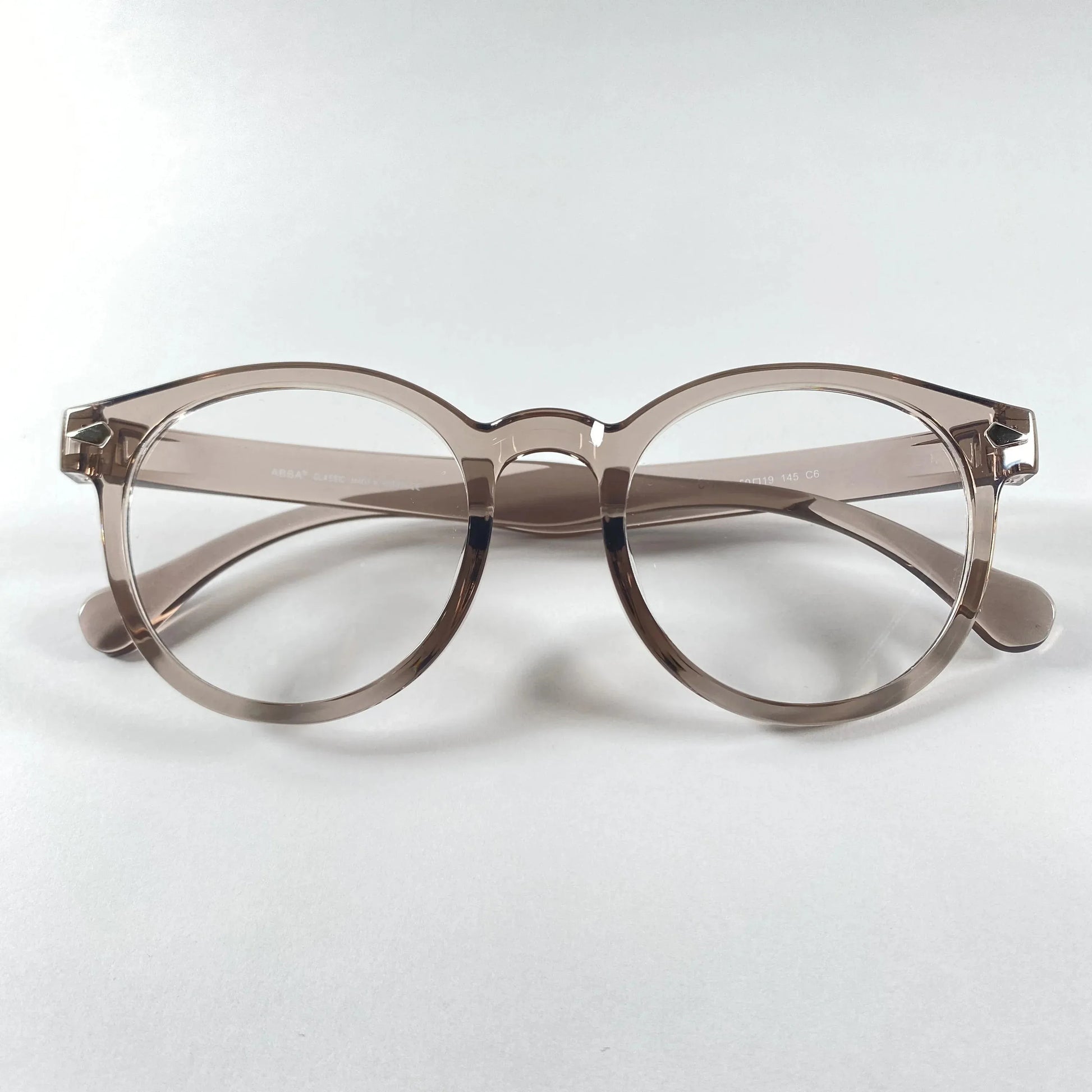 Round grey transparent eyeglasses with clear lenses on white background