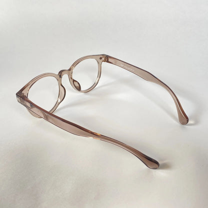 Round grey transparent eyeglasses with thick frames on a white background