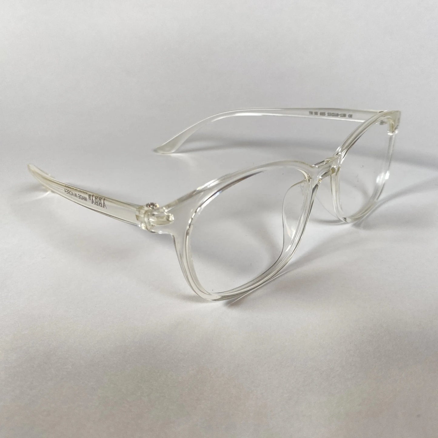 Clear sporty eyeglasses with transparent frames on a white background