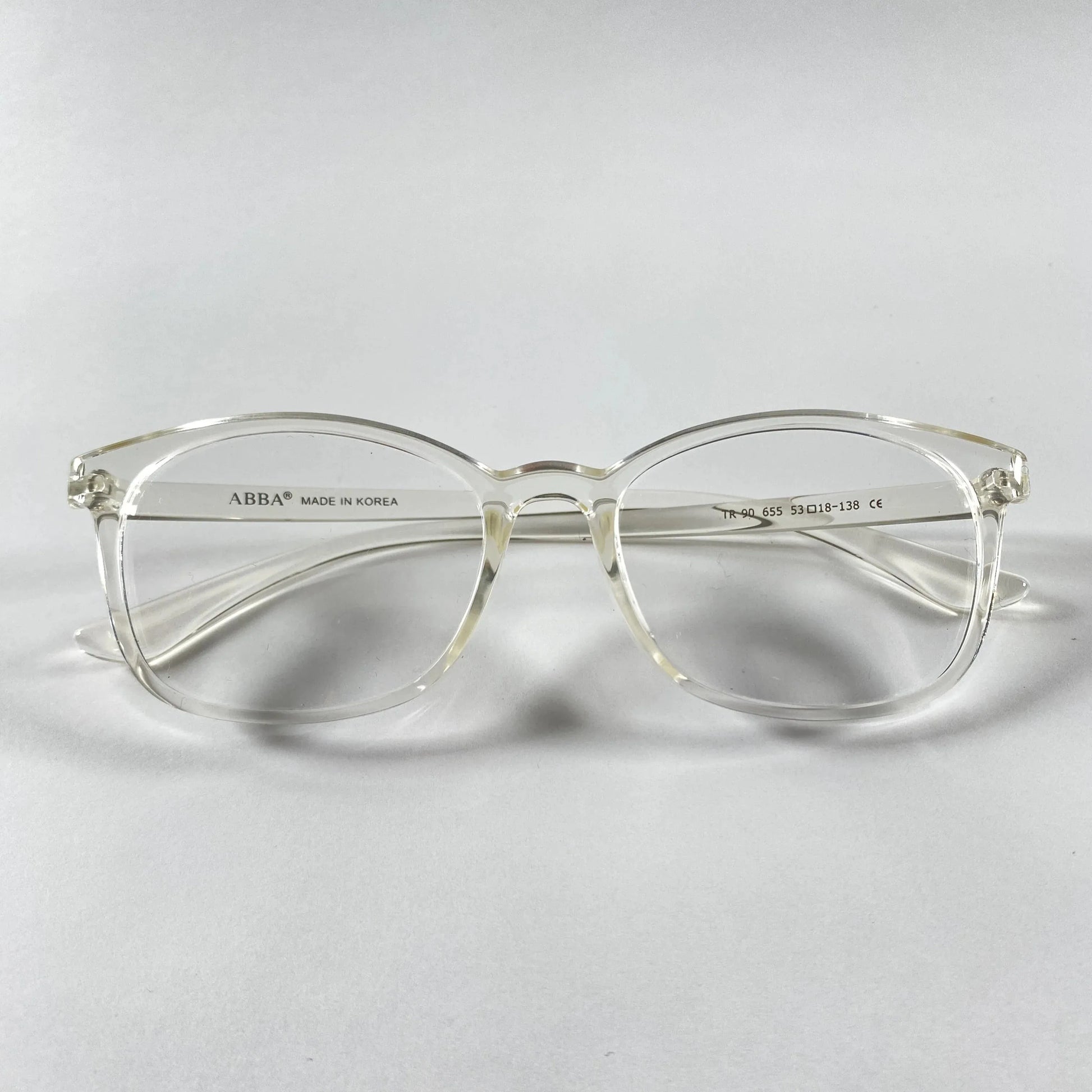 Clear Vion eyeglasses with transparent frame on white background, sporty style detail