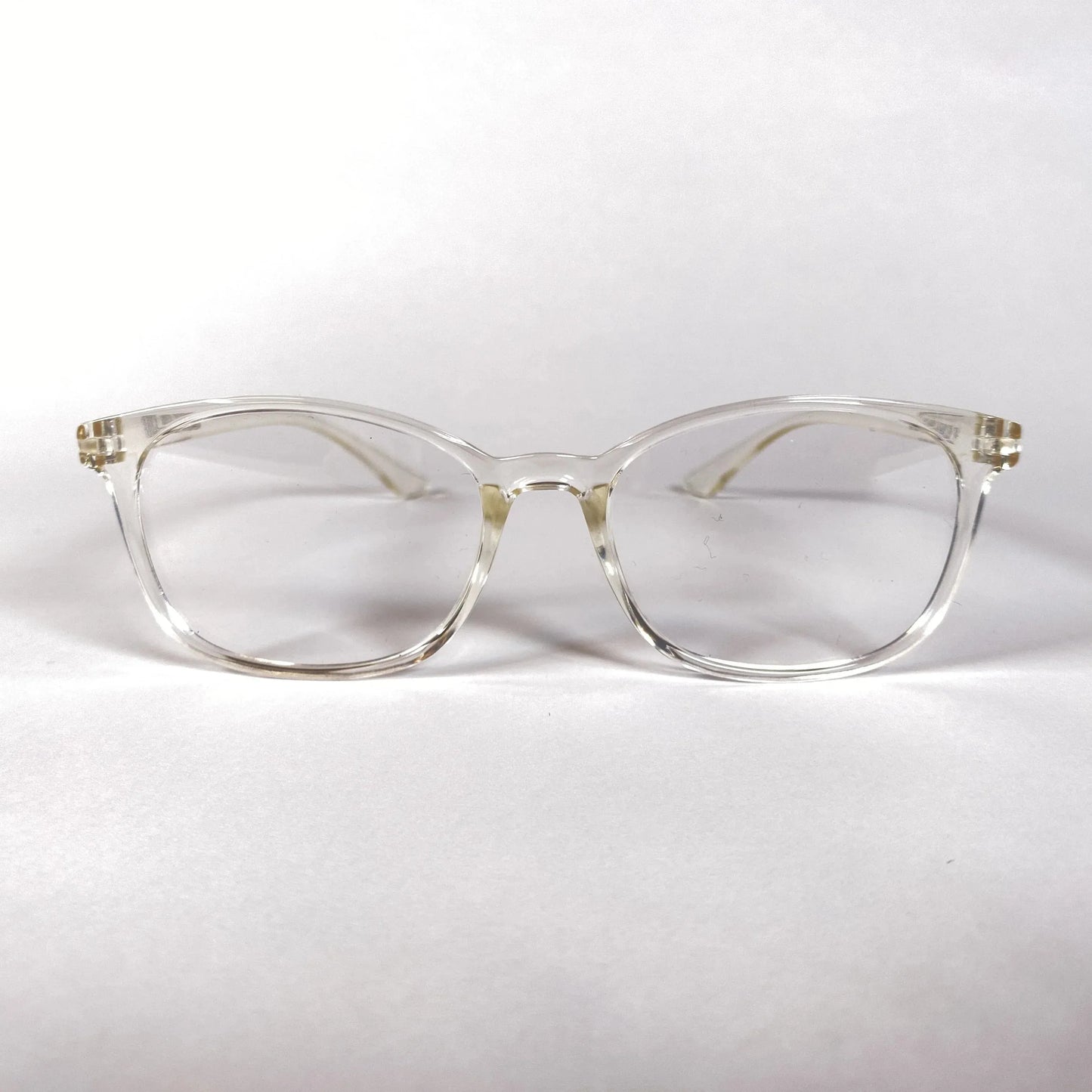 Clear plastic sporty eyeglasses with a round frame on a white background