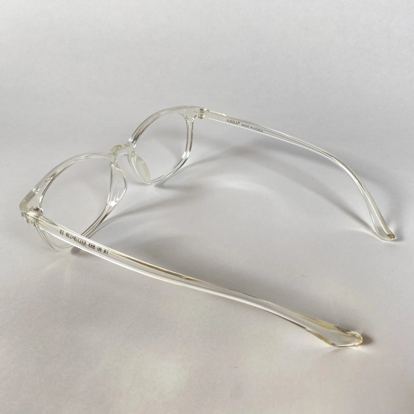 Clear transparent sporty eyeglasses with round frames on white background