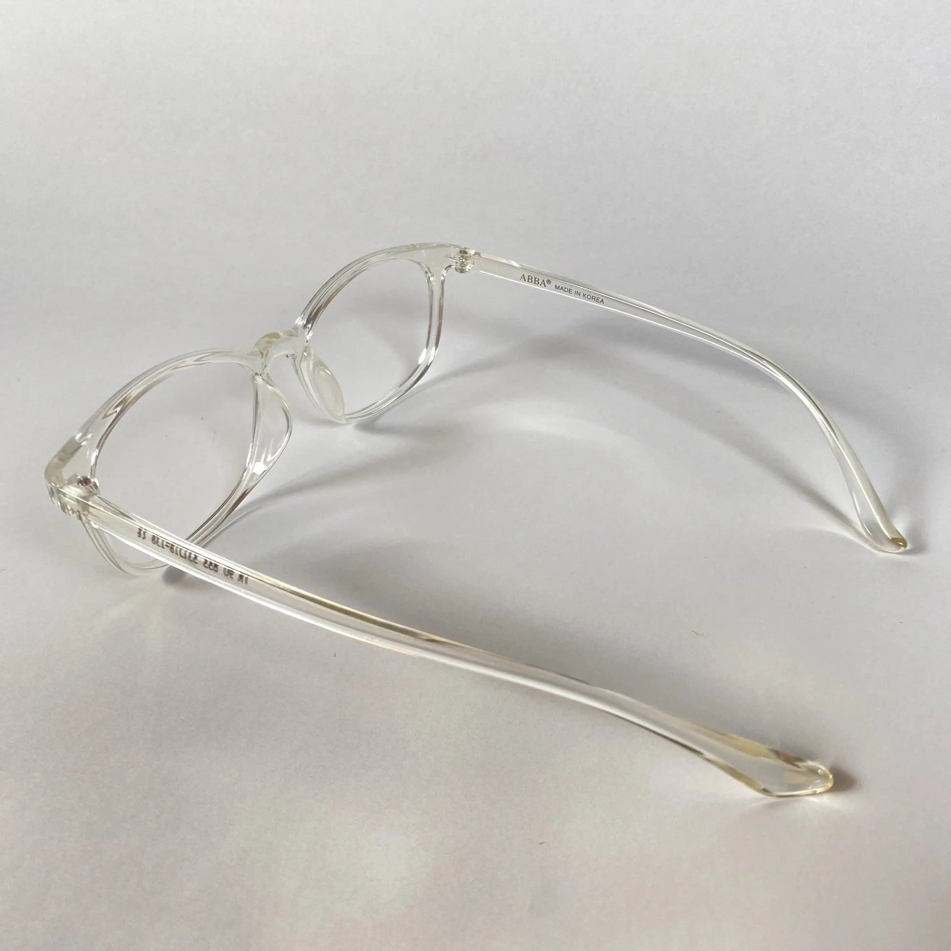 Clear transparent sporty eyeglasses with round frames on white background